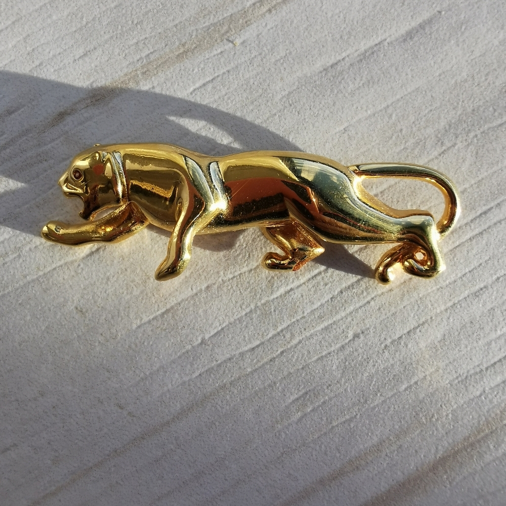 Gold Panther Brooch with an orange gemstone eye